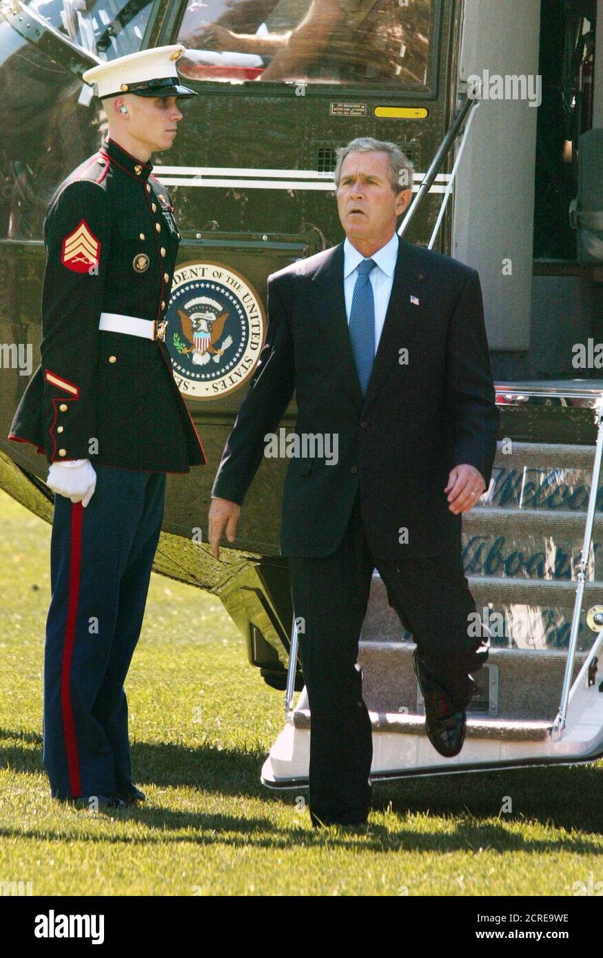 U.S. President George W. Bush steps off the Marine One helicopter on the South Lawn of the White House after returning from New York, September 13, 2002. Bush said on Thursday that Iraqi President Saddam Hussein had engaged in a 'decade of defiance' of post-Gulf War U.N. demands by developing weapons of mass destruction. He urged the United Nations to enforce its own resolutions and said if it did not, 'action will be unavoidable.' REUTERS/Hyungwon Kang  HK/HB Stock Photo