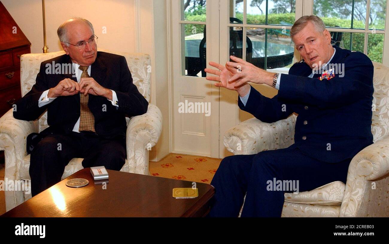 Chairman of the United States Joint Chiefs of Staff, General Richard Myers (R), gestures during a meeting with Australian Prime Minister John Howard at Howard's Sydney residence January 16, 2004. General Myers is visiting Australia as part of a nine-day international tour. REUTERS/Rick Rycroft/Pool  RR/MY Stock Photo