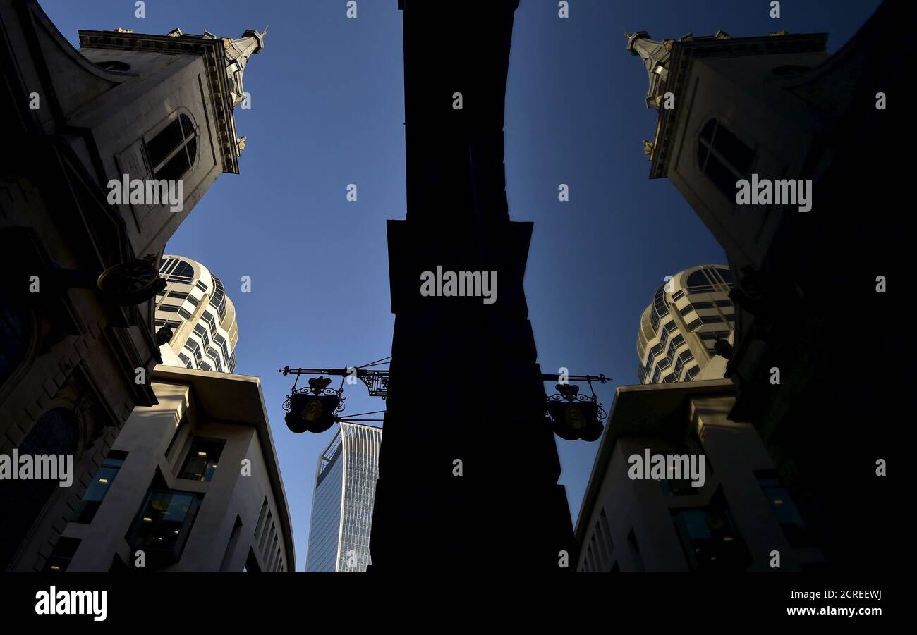 St. Edmund the King church is reflected in an office building in the City of London business district, Britain November 2, 2015. The architectural landscape of London never stands still. The City of London, as the largest financial services and banking centre in Europe, is no exception. Silhouettes of cranes pepper the horizon and buildings shoot skywards. Amid all this change there appears to be one constant: over 50 churches and other places of worship remain in the Square Mile. REUTERS/Toby Melville PICTURE 4 OF 15 - SEARCH 'MELVILLE WORSHIP' FOR ALL IMAGES TPX IMAGES OF THE DAY Stock Photo
