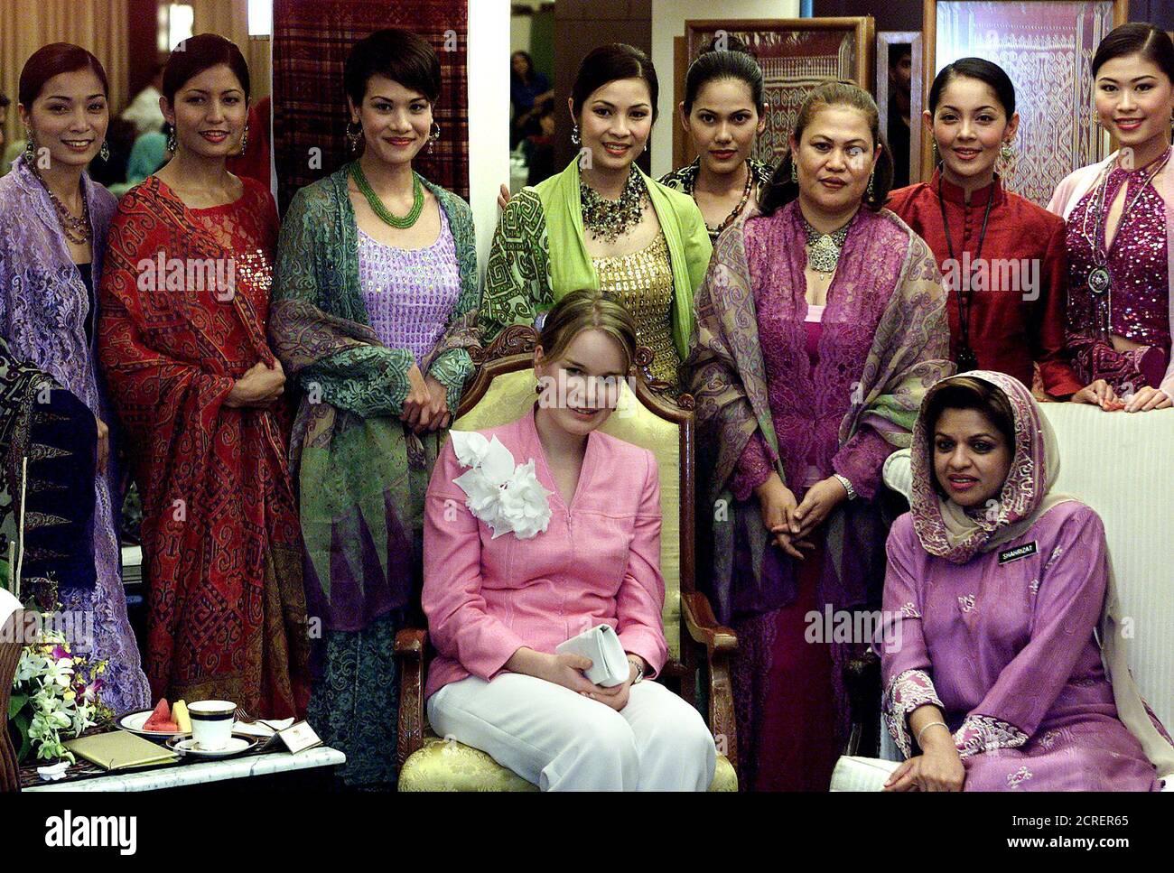 Belgian Princess Mathilde C Wife Of Crown Prince Philippe And Datuk Sharizat Bte Abdul Jalil R Minister Of Women And Family Development Pose With Models After Attending A Fashion Show In Kuala