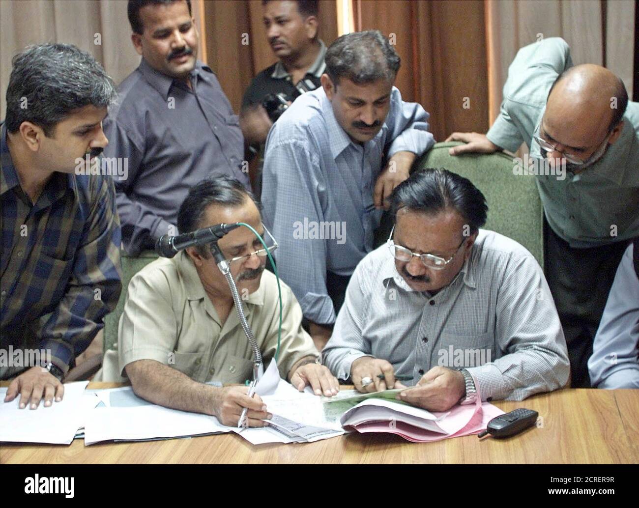 Election officials scrutinize nomination papers in Karachi on August 28, 2002. Scrutiny of nominations papers filed by candidates hoping to contest October 10 elections continued for a second day and will end on September 2. REUTERS/Zahid Hussein  ZH/JD Stock Photo