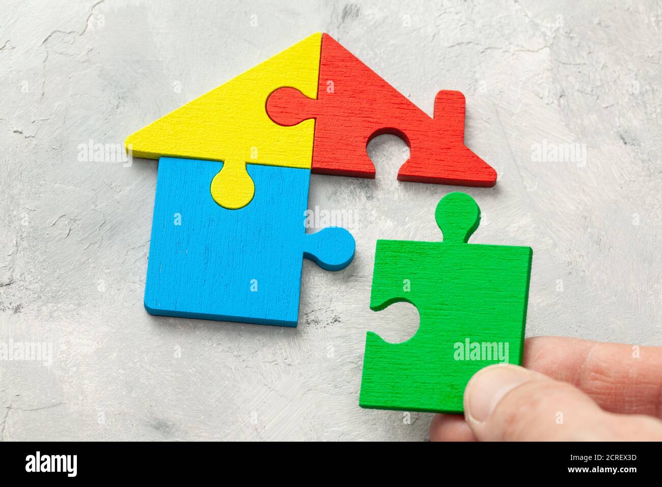 House puzzle Home loan. Parts of the house are brought together. Male