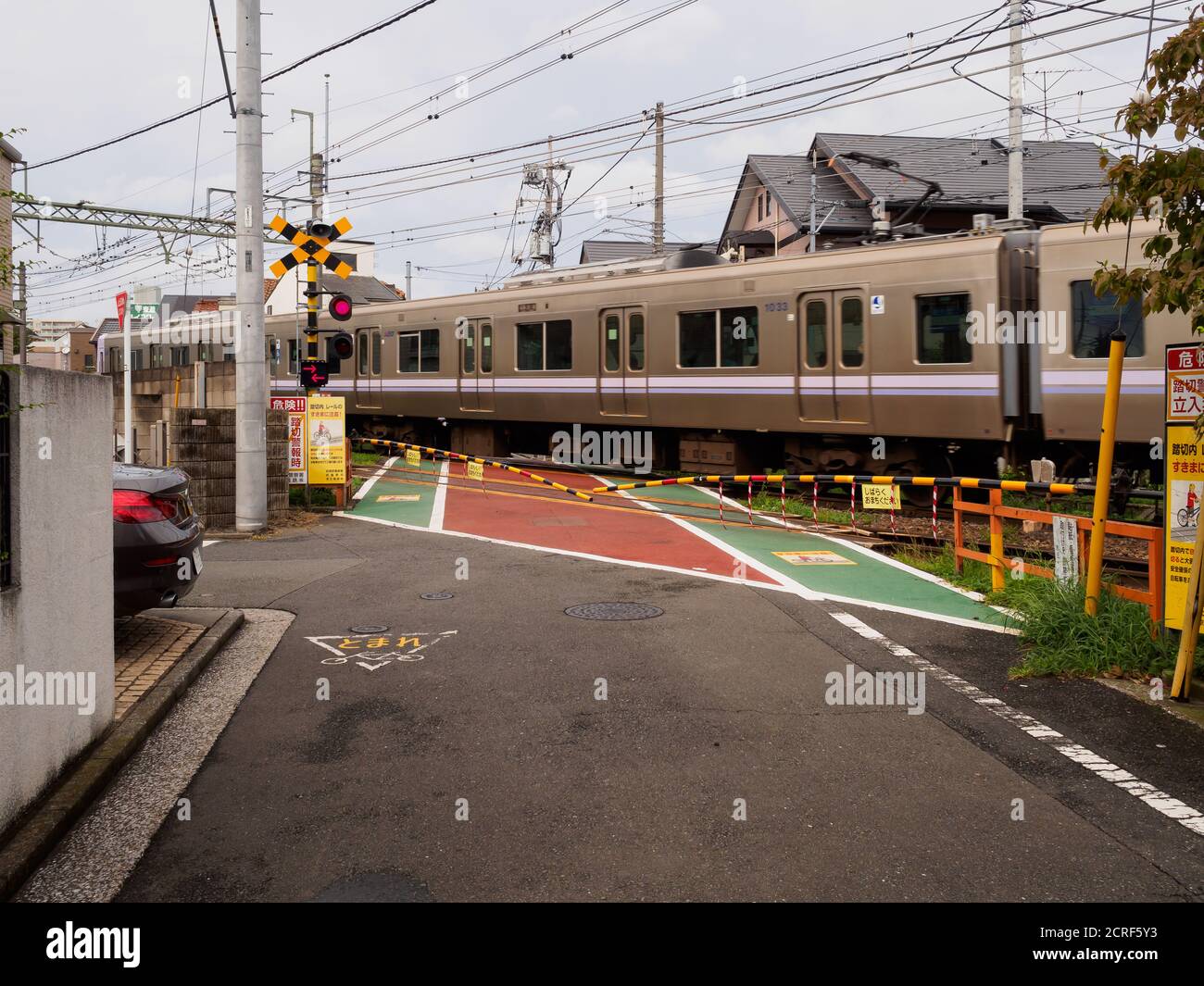Inokashira line train at a level crossing in Kichijoji, Tokyo, Japan. Stock Photo