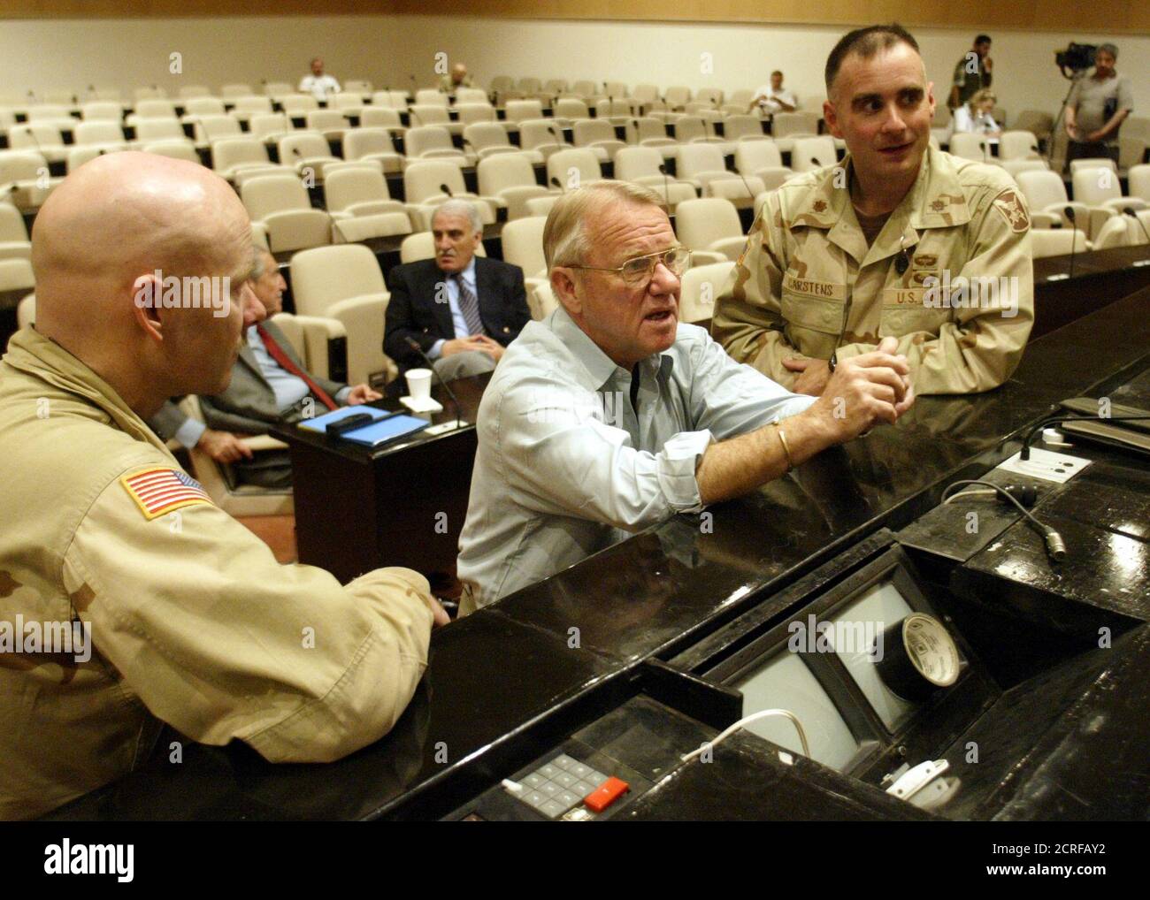 United States retired General Jay Garner (C), Iraq's civilian  administrator, studies a map of Bagdad with military personnel before a  meeting with nearly 100 Iraqis community leaders in Baghdad on April 29,