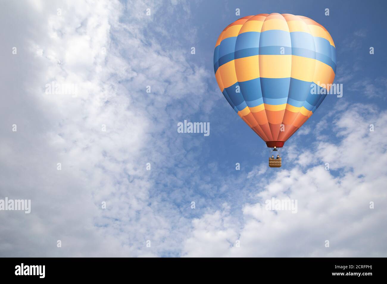 Hot air balloon set against a blue cloudy daytime sky Stock Photo