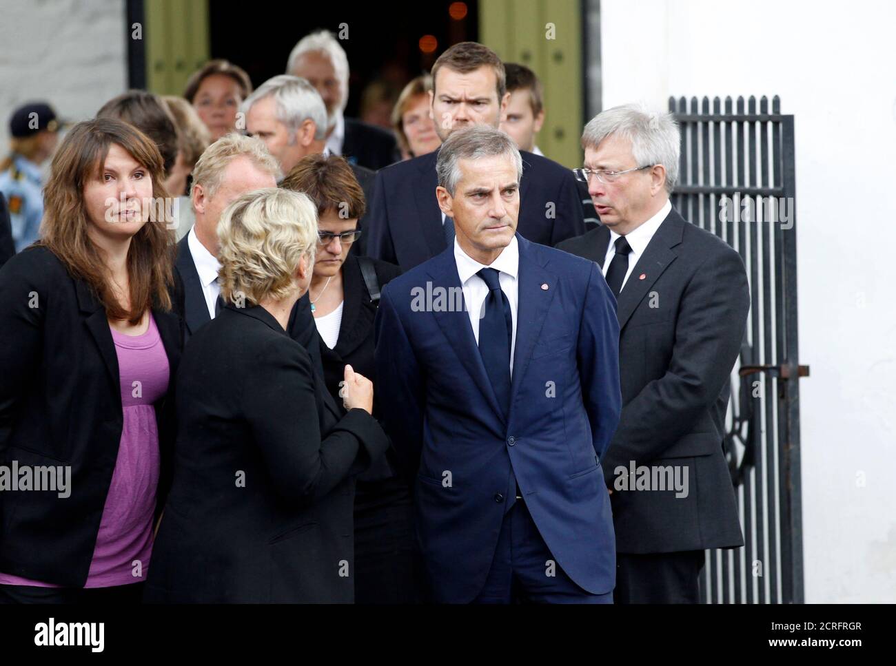 Norwegian Foreign Minister Jonas Gahr Store (2nd R) and relatives leave after a memorial service for the victims of a rampage on nearby Utoeya island at a church in Sundvollen, July 24, 2011. A right-wing zealot who admitted to bomb and gun attacks in Norway that killed 92 people on Friday claims he acted alone, Norway's police said on Sunday.  REUTERS/Fabrizio Bensch (NORWAY - Tags: CIVIL UNREST CRIME LAW POLITICS) Stock Photo