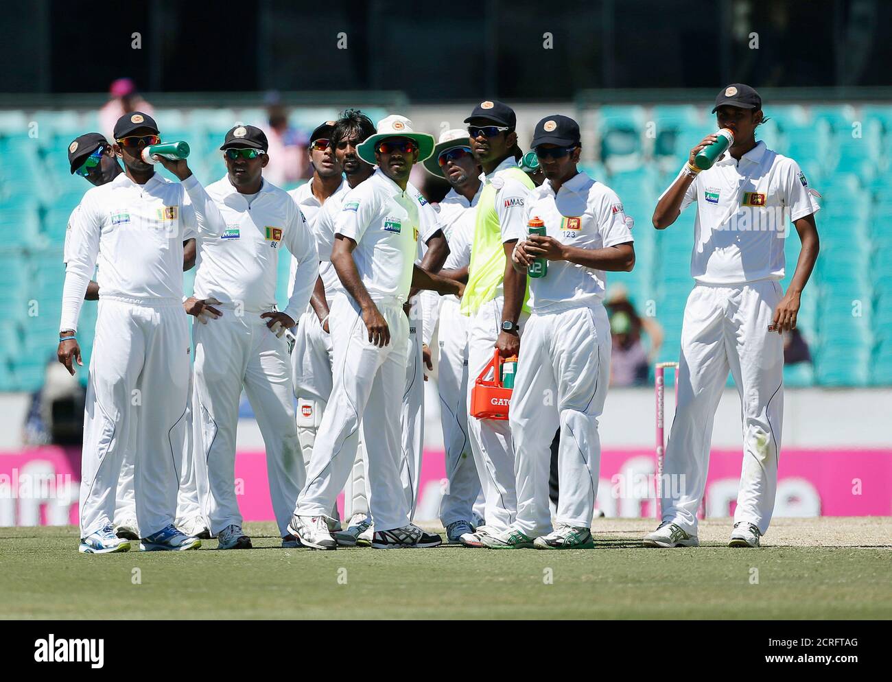 Sri Lanka players look at a scoreboard as they wait for a third umpire's decision during the third day's play of the third cricket test match against Australia at the Sydney Cricket Ground January 5, 2013.         REUTERS/Tim Wimborne (AUSTRALIA - Tags: SPORT CRICKET) Stock Photo