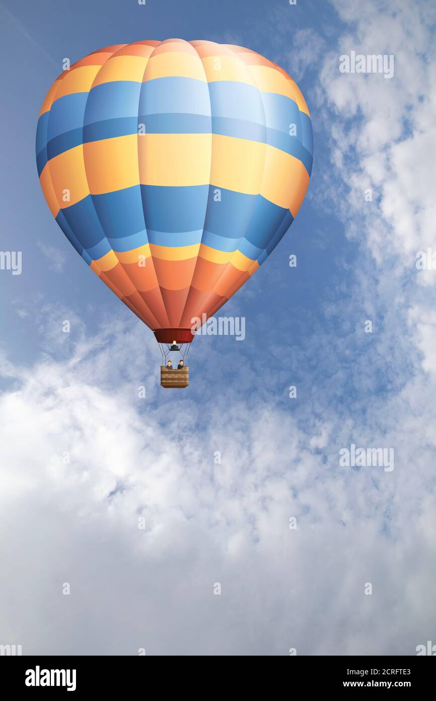 Hot air balloon set against a blue cloudy daytime sky Stock Photo
