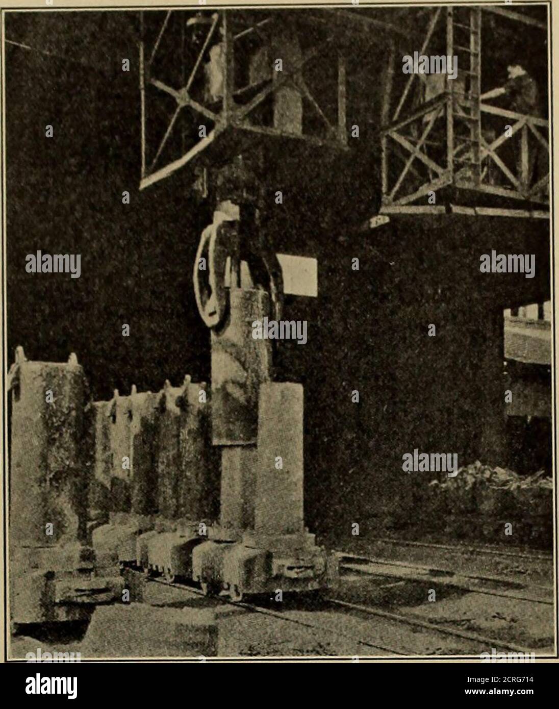 . Steel rails; their history, properties, strength and manufacture, with notes on the principles of rolling stock and track design . Fig. 271. — Teeming Ingots at Open-hearth Furnace. (Copyright, Koistoae iov Co.) ingot mold cars are run under the stripper, shown in Fig. 272, from which hooksare lowered and engage the lugs on either side of the mold and lift it off theingot. The ingot is then taken up by a traveling crane and conveyed to the re-heating furnaces or soaking pits, shown by Figs. 273 and 274, to allow the tem-perature in all parts of the ingot to become equalized before rolling. Stock Photo
