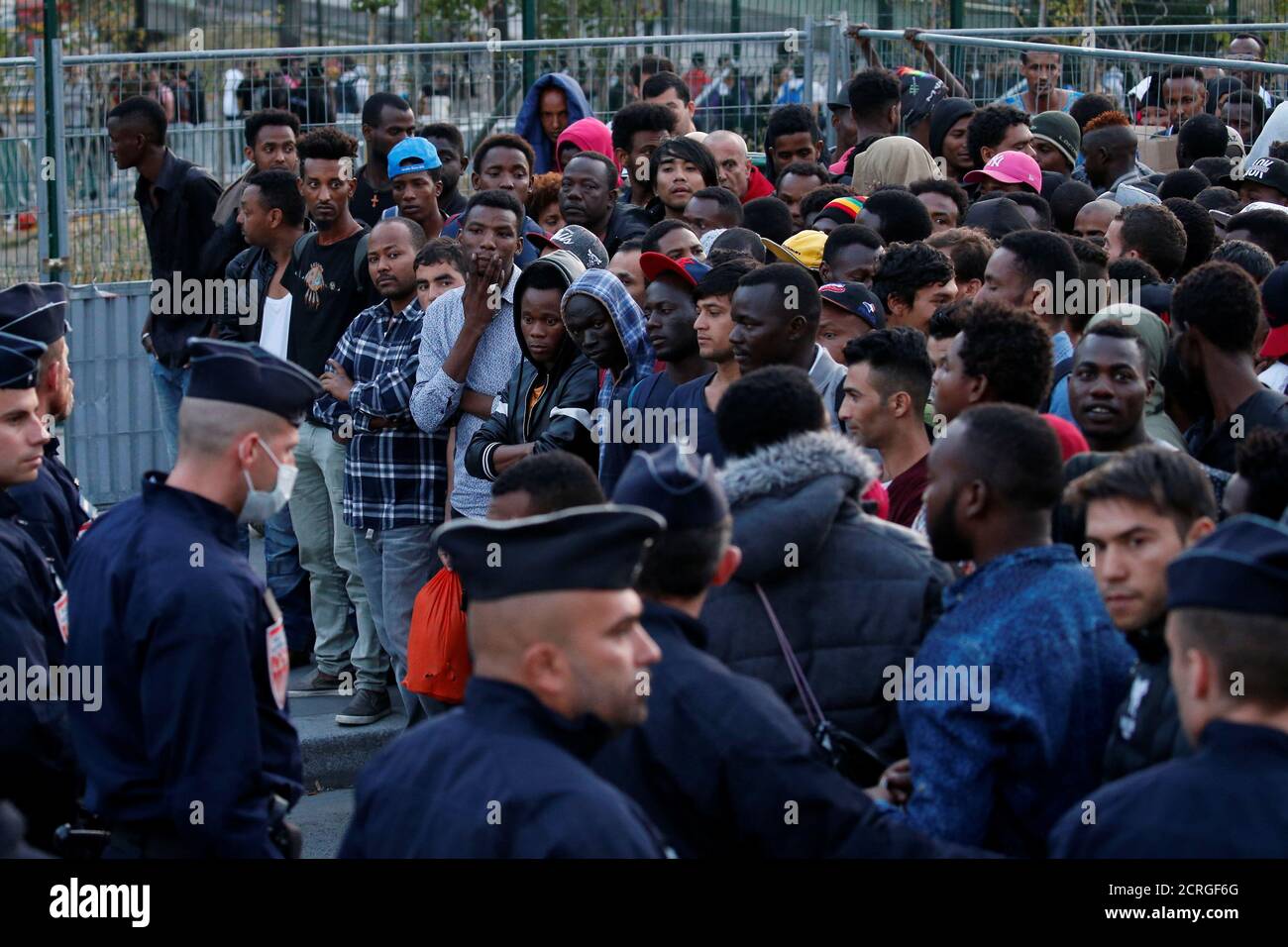 French police evict thousands of migrants living on sidewalks near the  reception center for migrants and