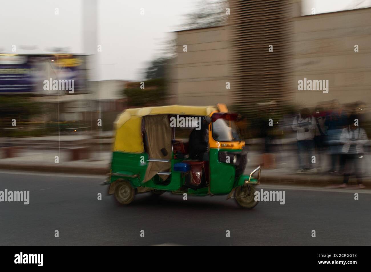 panning technique of indian auto rickshaw going somewhere at evening with passenger Stock Photo