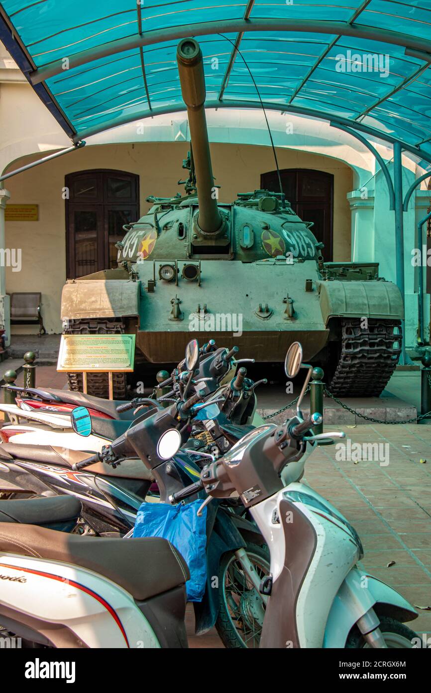 HANOI, VIETNAM, APR 20 2019, motorcycles parked in front of an old Russian tank, areal of museum Stock Photo