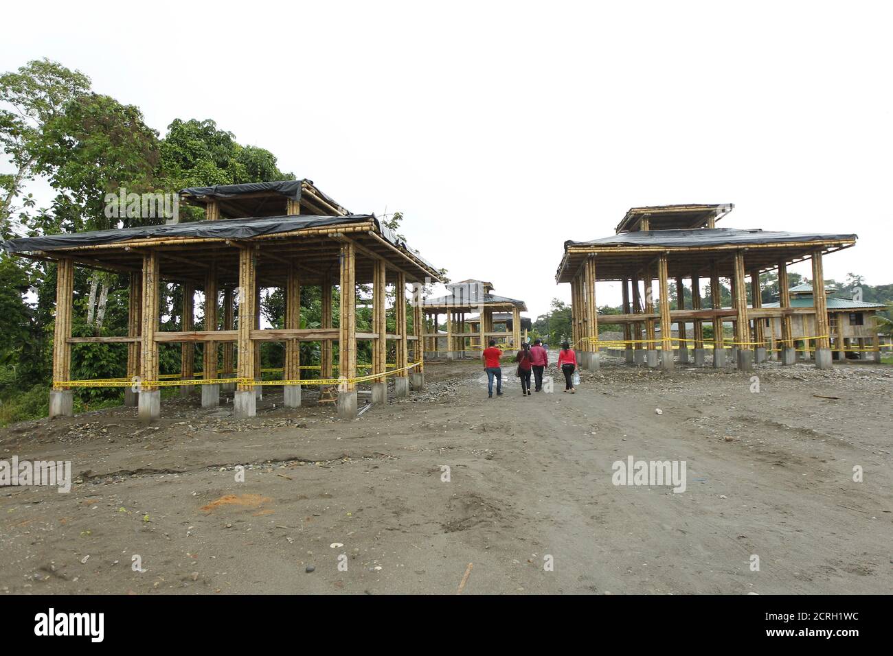 Cofan indigenous people walk near new houses constructed by the government administration in the Quichua community at Dureno, Ecuador, March 26, 2016.REUTERS/Guillermo Granja Stock Photo