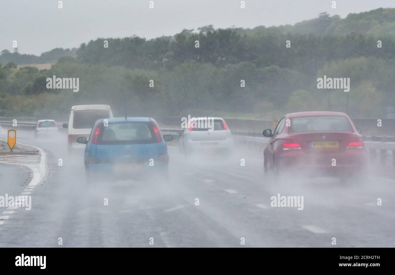 Drivers driving cars on a Dual Carriageway during heavy rain with poor visibility in England, UK. Bad weather and wet, dangerous road while raining. Stock Photo