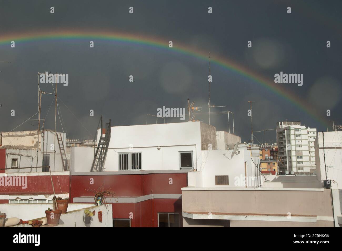Rainbow over the houses of a city. Schamann. Las Palmas de Gran Canaria. Gran  Canaria. Spain Stock Photo - Alamy