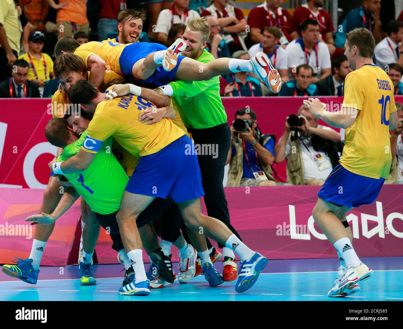 Sweden's team players celebrate after defeating Hungary in their men's semi-final match at the Basketball Arena during the London 2012 Olympic Games August 10, 2012.       REUTERS/Adrees Latif (BRITAIN  - Tags: SPORT HANDBALL OLYMPICS) Stock Photo