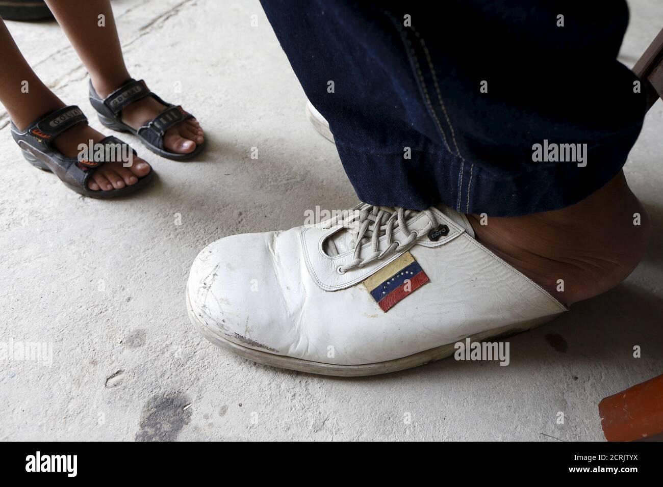 Jeison Rodriguez L 19 The Living Person With The Largest Feet In The World Poses For A Picture With His Older Brother Wilmer 24 Outside Their House In Maracay Venezuela October 14