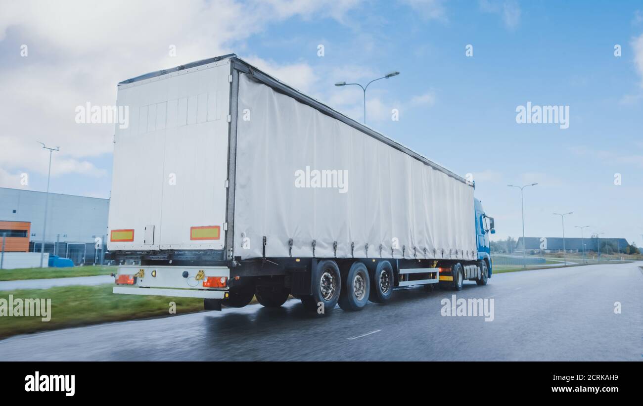 Long Haul SemiTruck with Cargo Trailer Full of Goods Travels on the
