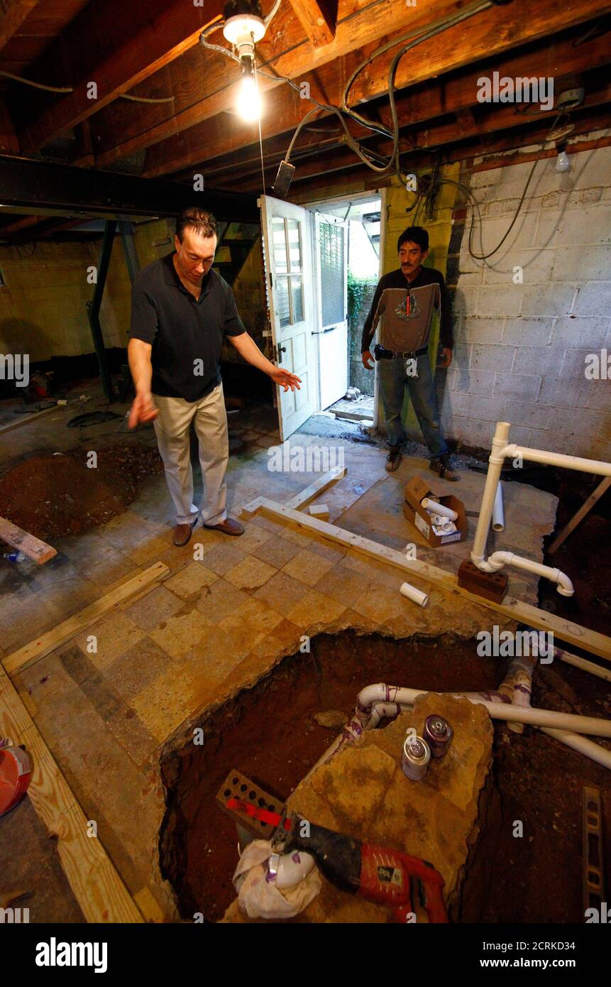 Real estate investor Lance Young (L) talks with his contractor Rene Sanzetenea (R) about a basement renovation as he tours one of the houses that he has purchased to renovate and resell in the Washington suburb of Arlington, Virginia, June 29, 2011. Young buys several discounted or distressed houses a year and then tries to make a substantial profit after performing major renovations on them. Often blamed for helping to create the U.S. housing boom and crash by driving up prices, investors are now welcomed as a key support for the battered property market. Picture taken June 29, 2011. To match Stock Photo