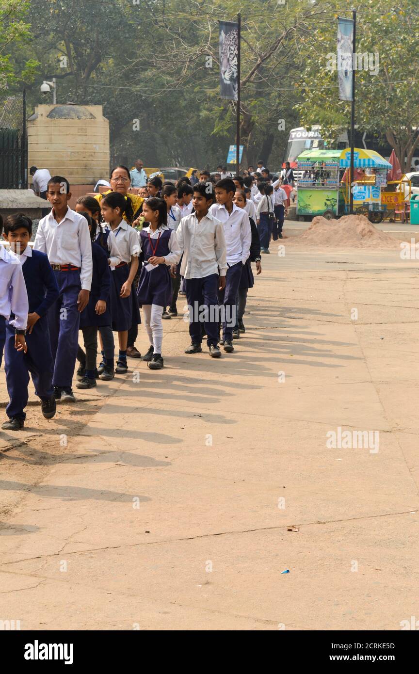 A bunch of children going to visit national zoological park standing in queue outside of Delhi Zoo. Stock Photo