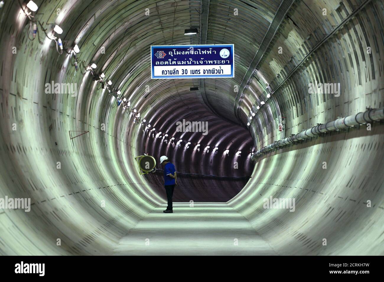 A construction worker stands inside a tunnel under the Chao Phraya river at a Mass Rapid Transit subway station in Bangkok, Thailand, December 14, 2015. REUTERS/Athit Perawongmetha Stock Photo
