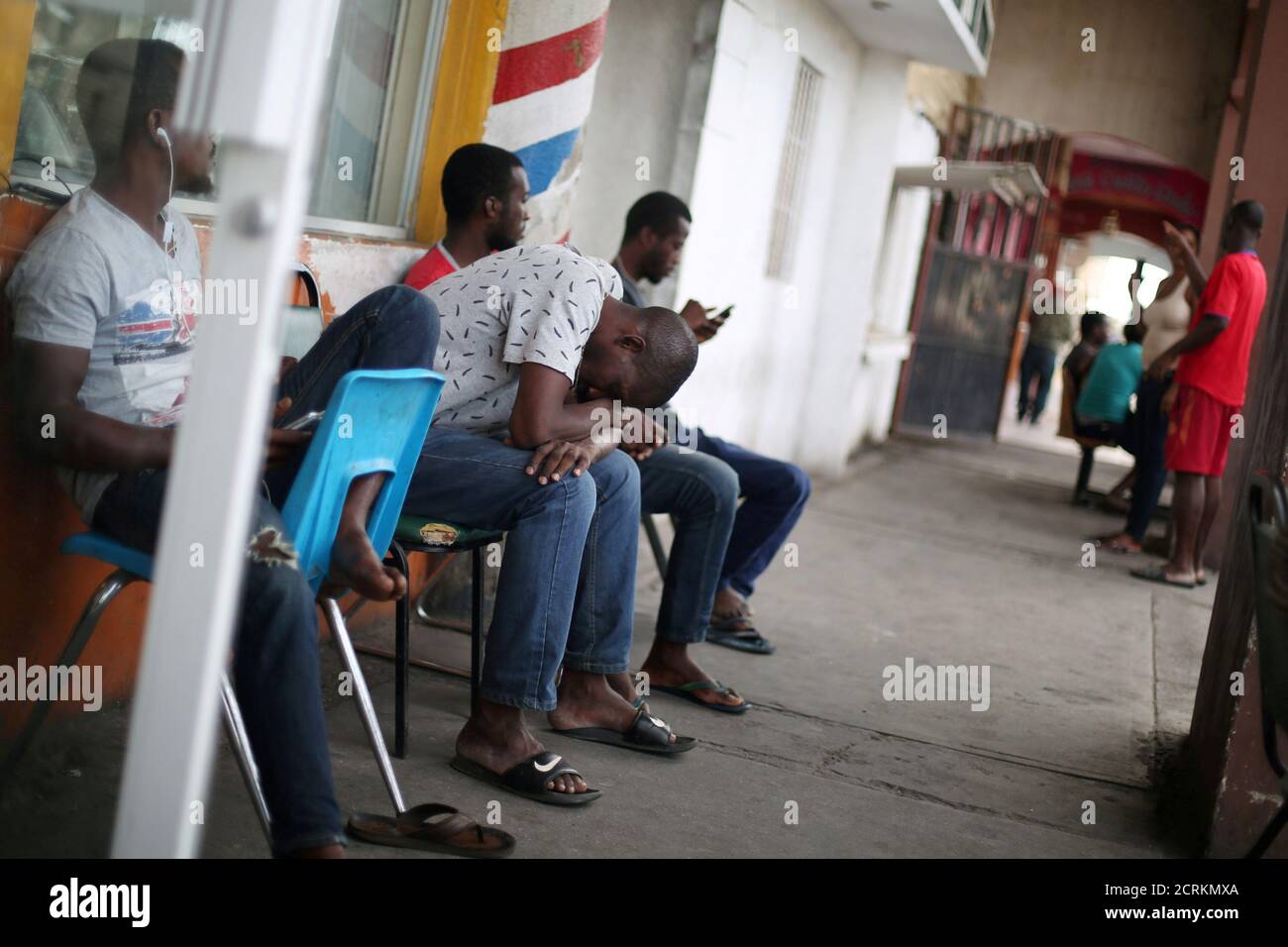 Congolese migrants intending to seek asylum in the U.S. sit outside a cybercafe in Mexicali, Mexico, October 5, 2016. REUTERS/Edgard Garrido Stock Photo