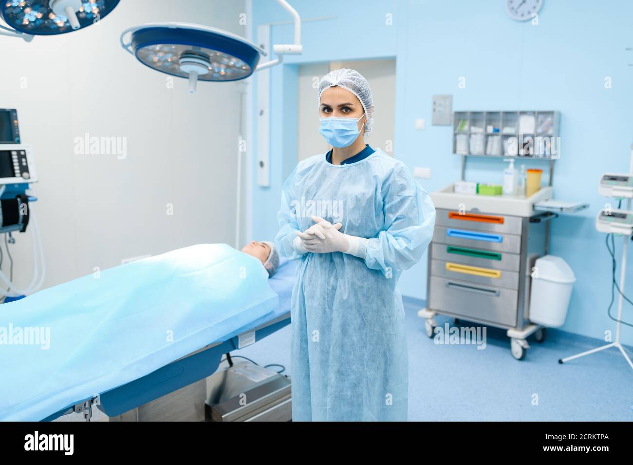 Surgeon in gown, mask and gloves in operating room Stock Photo Alamy