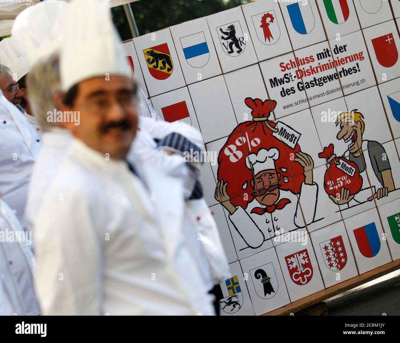 Members of Gastro Suisse pose next to boxes with some 119,290 signatures of the popular initiative against discrimination on the value added tax in gastronomy (Schluss mit der MwSt-Diskriminierung des Gastgewerbes!), outside the parliament building in Bern September 21, 2011. REUTERS/Pascal Lauener (SWITZERLAND - Tags: CIVIL UNREST POLITICS FOOD BUSINESS) Stock Photo