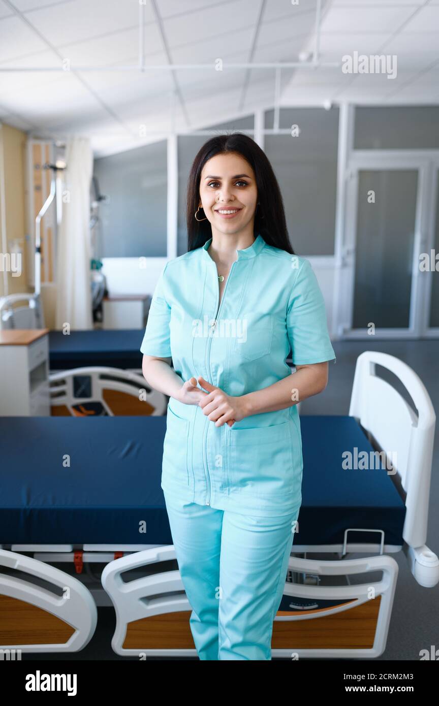 Smiling female surgeon poses at the bed in clinic Stock Photo - Alamy