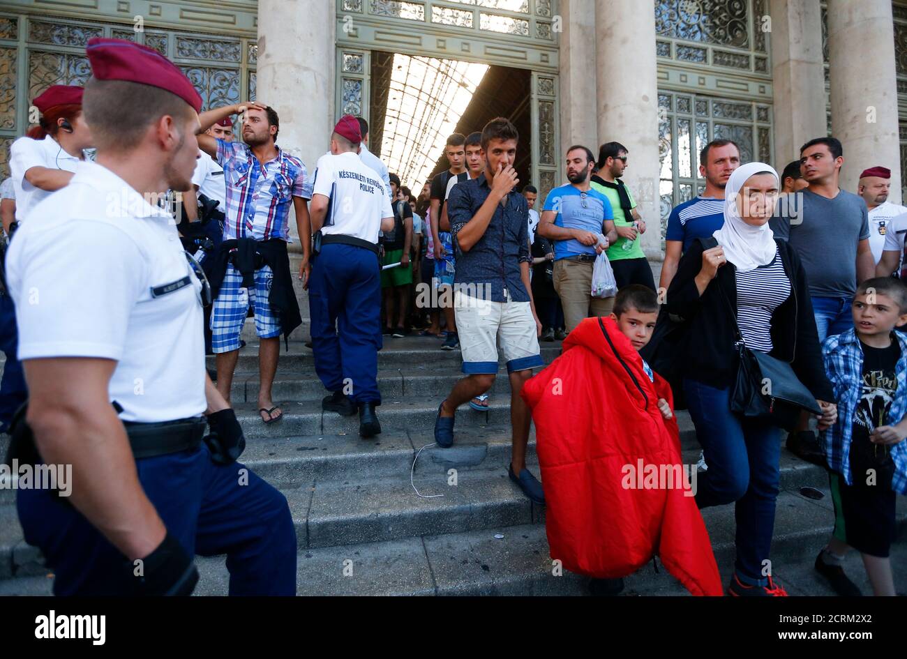 Migrants leave the main Eastern Railway station in Budapest, Hungary, September 1, 2015. Hungary closed Budapest's main Eastern Railway station on Tuesday morning with no trains departing or arriving until further notice, a spokesman for state railway company MAV said. There are hundreds of migrants waiting at the station. People have been told to leave the station and police have lined up at the main entrance, national news agency MTI reported. REUTERS/Laszlo Balogh Stock Photo