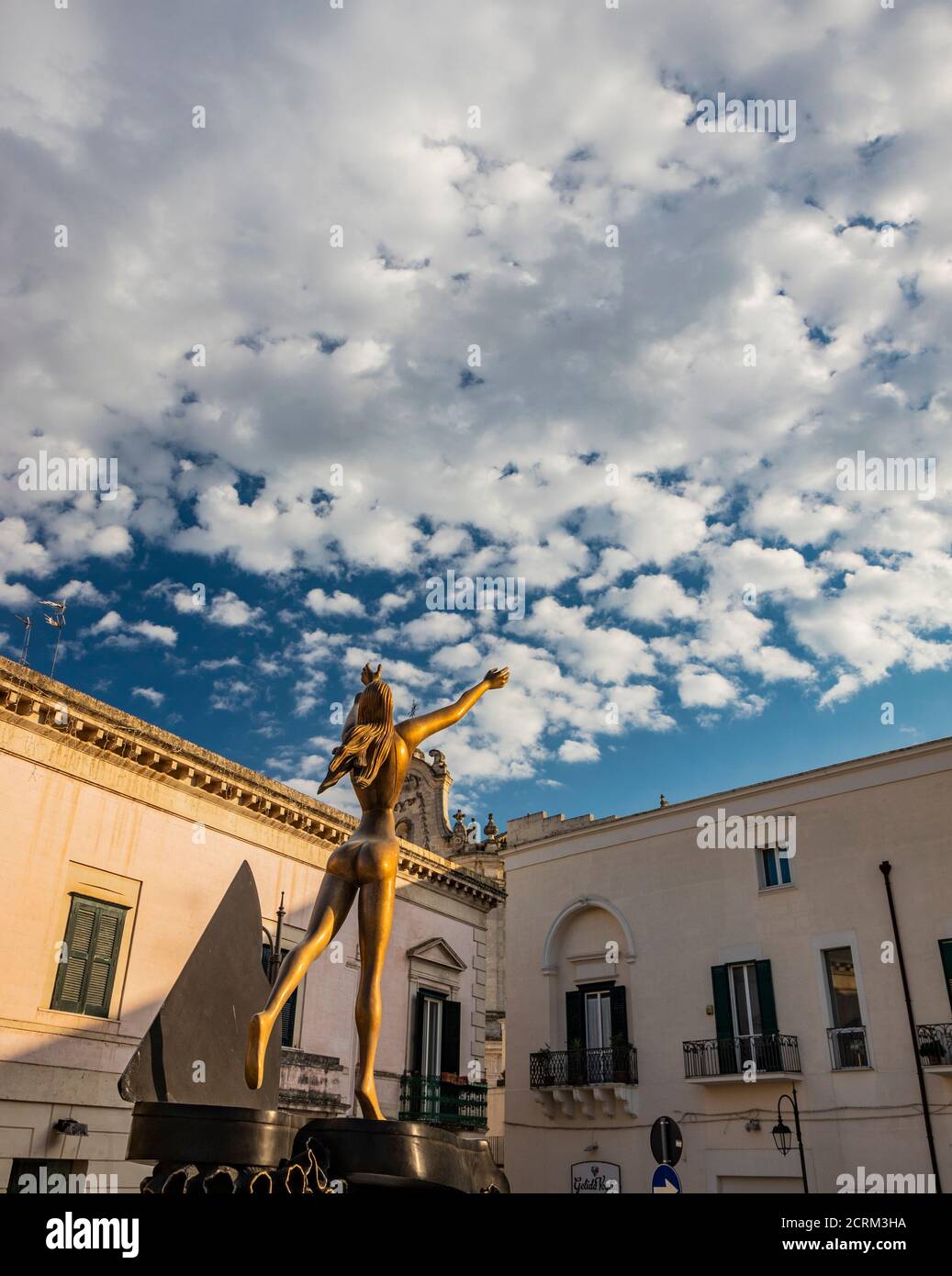 August 8, 2020 - Matera, Basilicata, Italy - Salvador Dalì's sculpture: the Dancing Piano, in San Francesco d'Assisi square. Woman with arms raised to Stock Photo