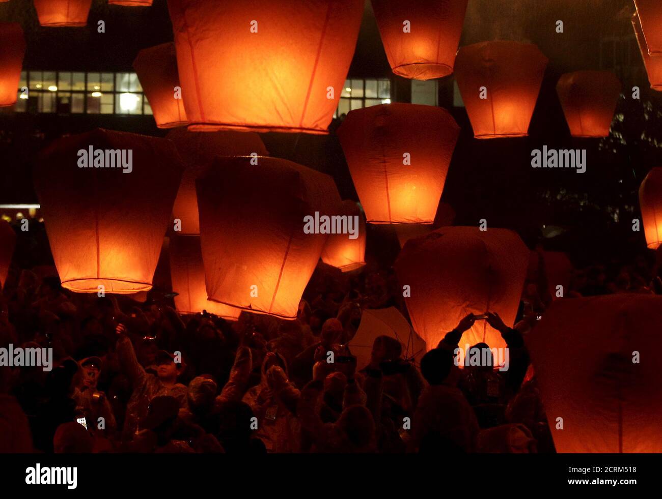 People release sky lanterns ahead of the traditional Chinese Lantern