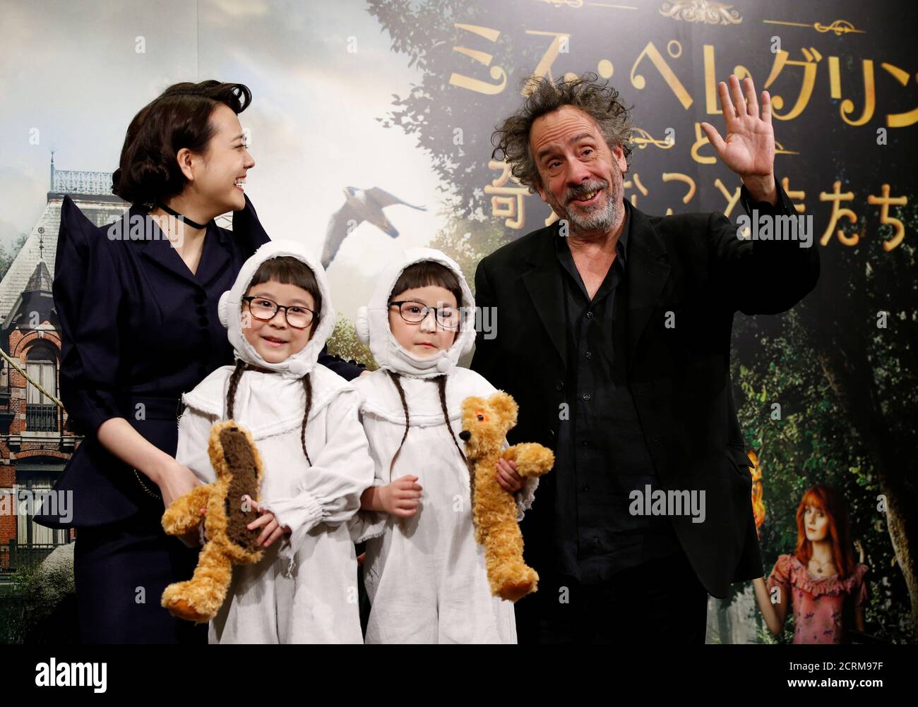 Director Tim Burton poses with Japanese models Airi Matsi (L), Rinka (2nd  R) and Anna at a news conference to promote his film "Miss Peregrine's Home  for Peculiar Children" in Tokyo, Japan,