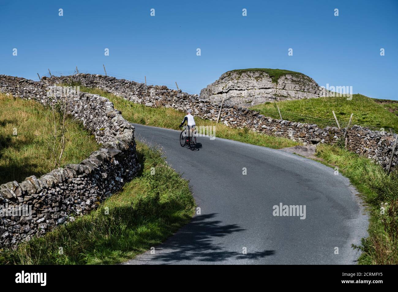 Male cyclist riding between Airton and Settle in the Yorkshire Dales, UK Stock Photo