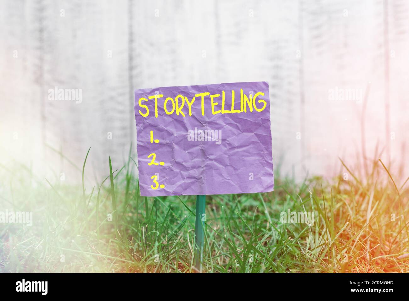 Conceptual hand writing showing Storytelling. Concept meaning relater of anecdotes, reciter of tales, writer of stories Plain paper attached to stick Stock Photo