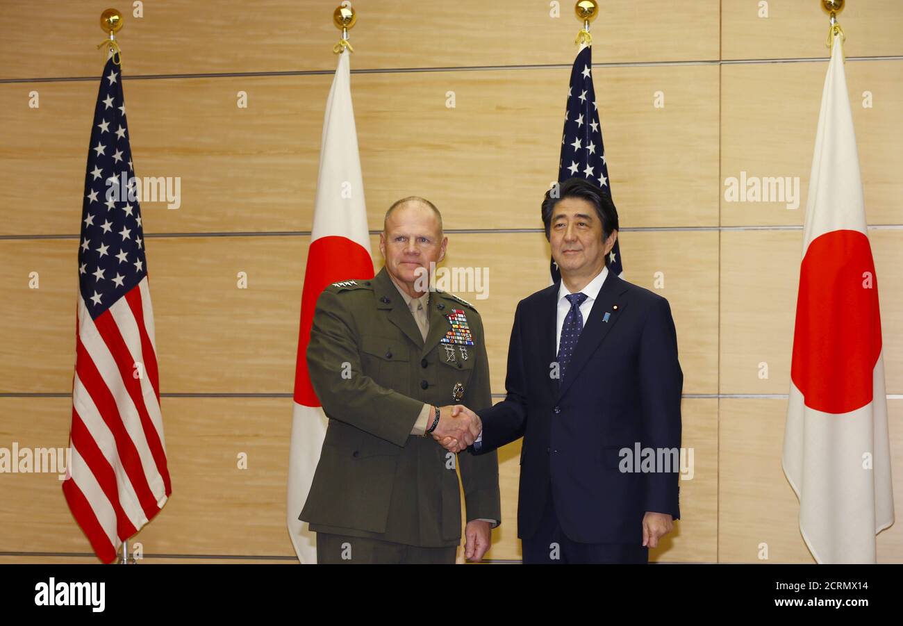 Gen. Robert B. Neller, Commandant of the U.S. Marine Corps, and Japanese Prime Minister Shinzo Abe pose for photographers prior to a meeting at Abe's official residence in Tokyo, November 25, 2015. REUTERS/Shizuo Kambayashi/Pool Stock Photo