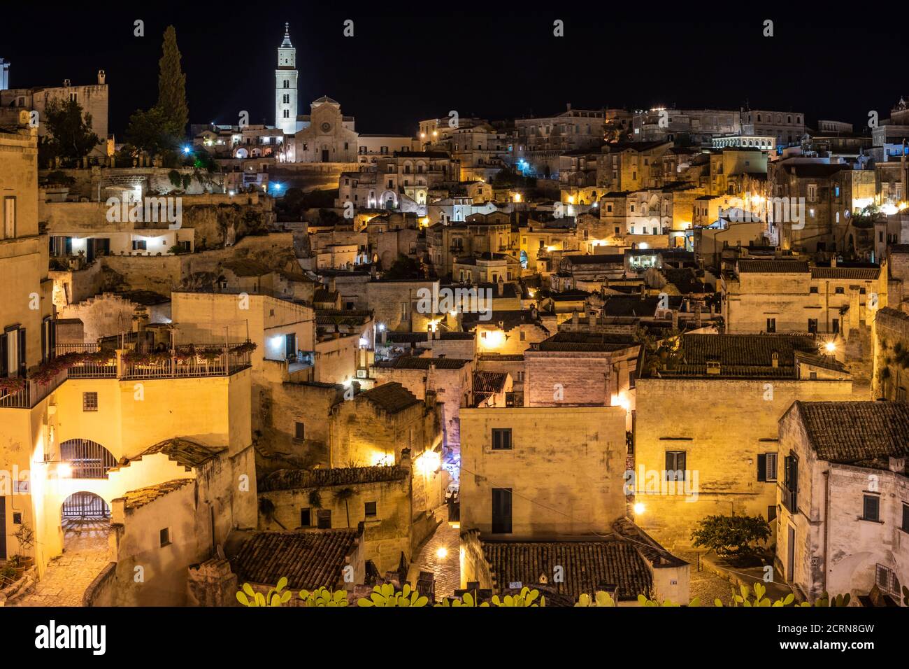 Matera, Basilicata, Italy - Panoramic view of the Sassi of Matera, Caveoso, at night. The ancient houses of stone and brick, carved into the rock. The Stock Photo