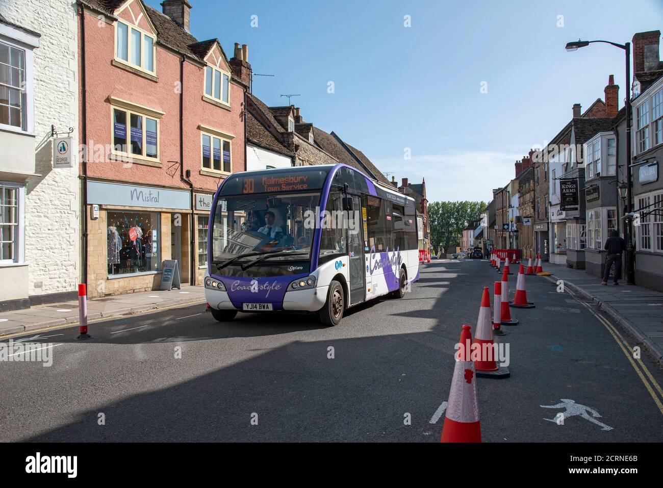 Malmesbury, Wiltshire, England, UK. 2020, Social distancing traffic cones and signage in the main street of this historic market town. Town service bu Stock Photo