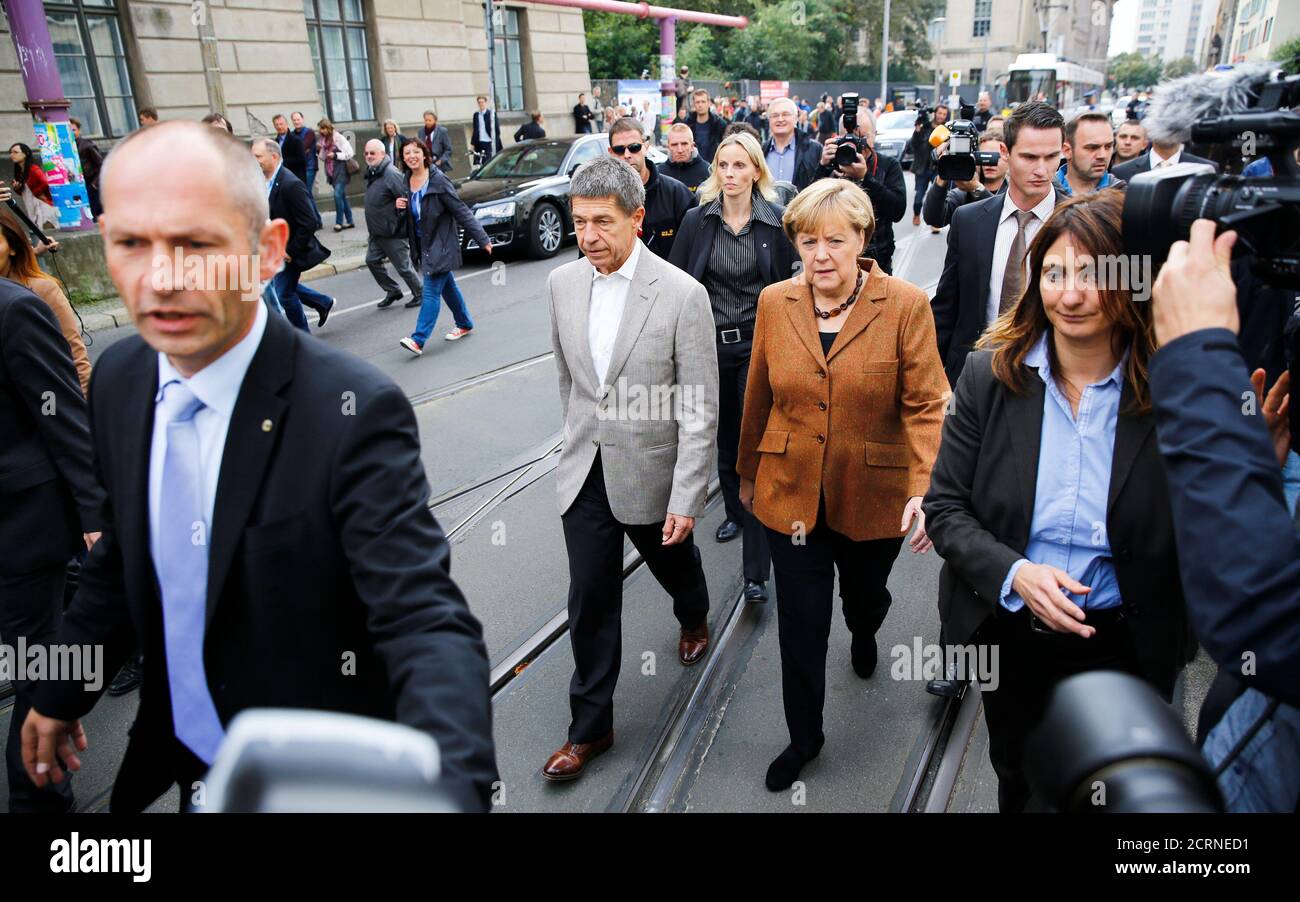 German Chancellor and leader of Christian Democratic Union (CDU) Angela Merkel and her husband Joachim Sauer arrive to vote in the German general election (Bundestagswahl) at a polling station in Berlin, September 22, 2013.     REUTERS/Thomas Peter (GERMANY  - Tags: POLITICS ELECTIONS) Stock Photo