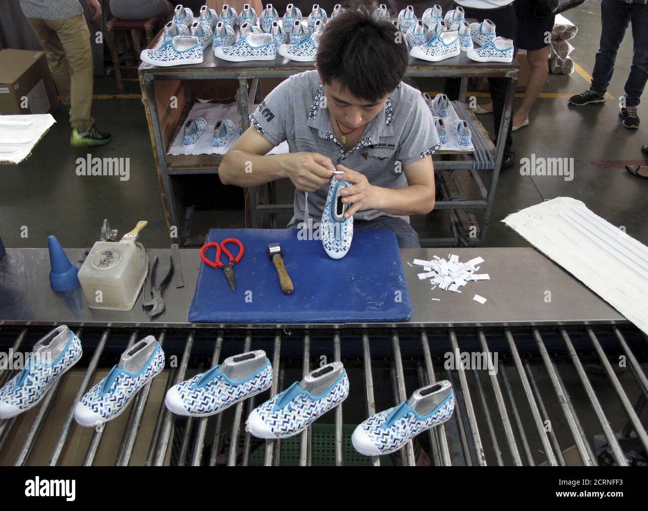 An employee works at a Shuangwei factory in Putian, Fujian province, China,  May 14, 2015. Criticised and even sued by luxury brand Gucci and others for  facilitating the counterfeit goods trade, Chinese