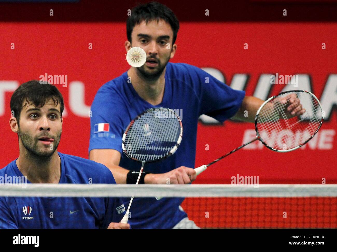 France's Baptiste Careme (R) and Ronan Labar hits a return to Indonesia's  Mohammad Ahsan and Hendra Setiawan during their men's double badminton  match at the BWF World Championship in Jakarta, August 12,