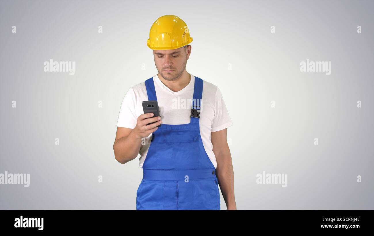 Factory worker employee chatting browsing texting on smartphone Stock Photo