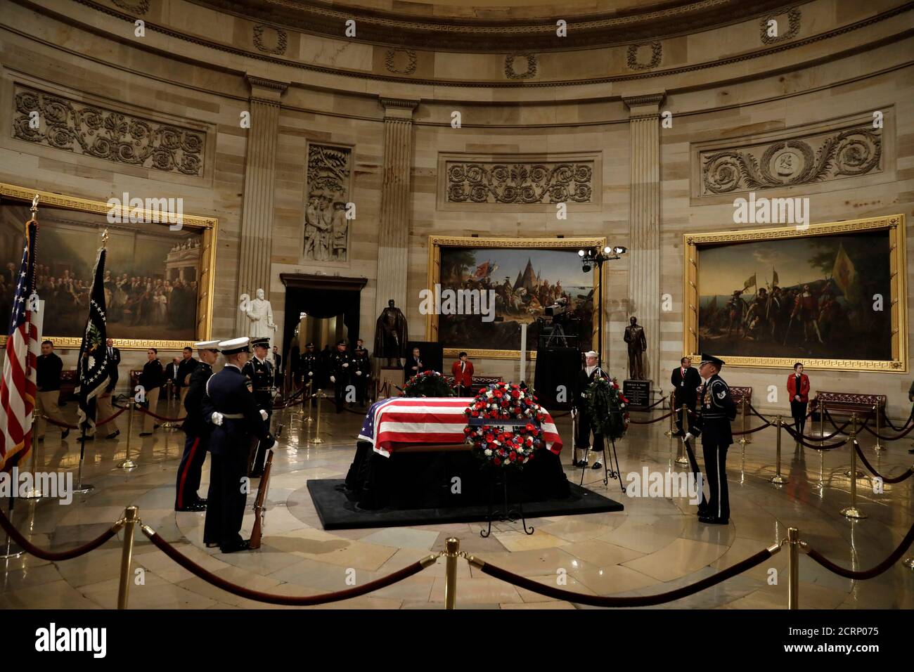 members-of-the-military-honor-guard-stand-at-the-flag-draped-casket-of-former-us-president-george-hw-bush-as-it-lies-in-state-inside-the-us-capitol-rotunda-in-washington-us-december-4-2018-reutersyuri-gripas-2CRP075.jpg
