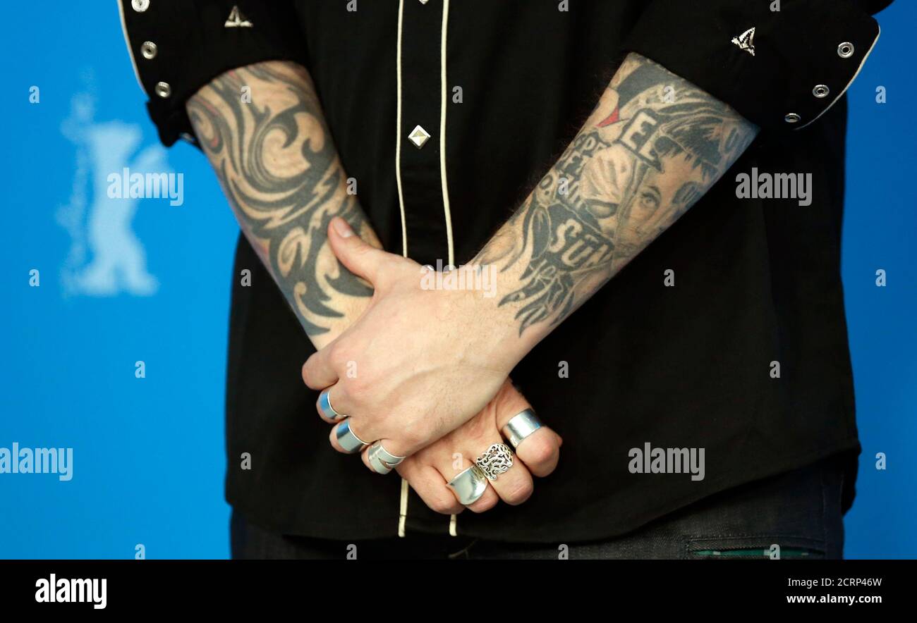 The arms covered with tattoos of director Denis Cote are pictured during a  photocall to promote the movie 