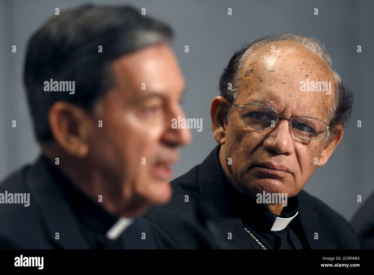 Cardinal Oswald Gracias (R) looks on as Cardinal Ruben Salazar Gomez speaks during a news conference at the Vatican, October 26, 2015. Roman Catholic leaders from around the world on Monday made a joint appeal to a forthcoming United Nations conference on climate change to produce a 'fair, legally binding and truly transformational' agreement.REUTERS/Alessandro Bianchi Stock Photo