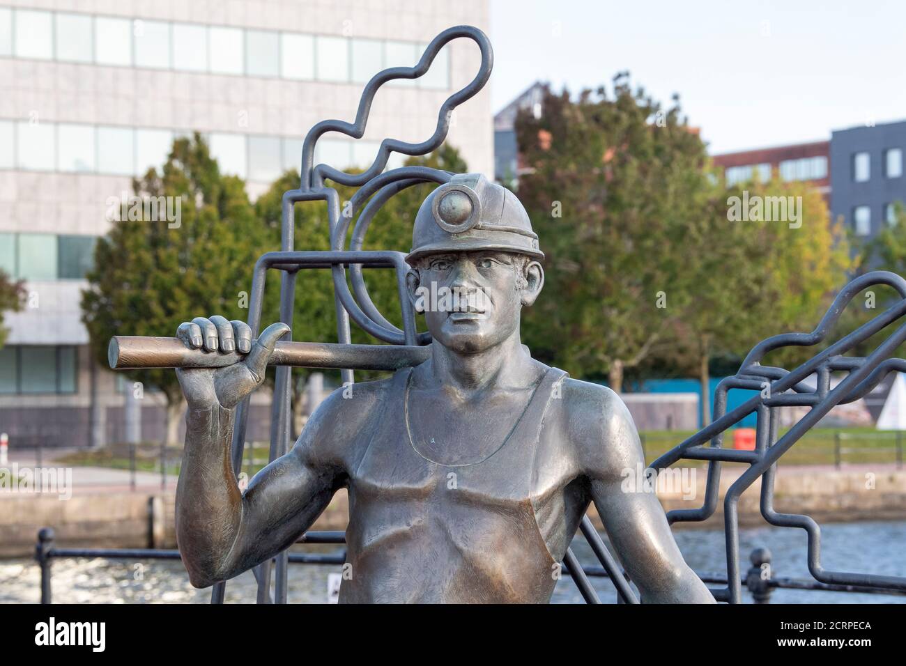 From Pit to Port, bronze statue of a Welsh coal miner, by John Clinch, Cardiff Bay, Cardiff, Wales, United Kingdom. Stock Photo