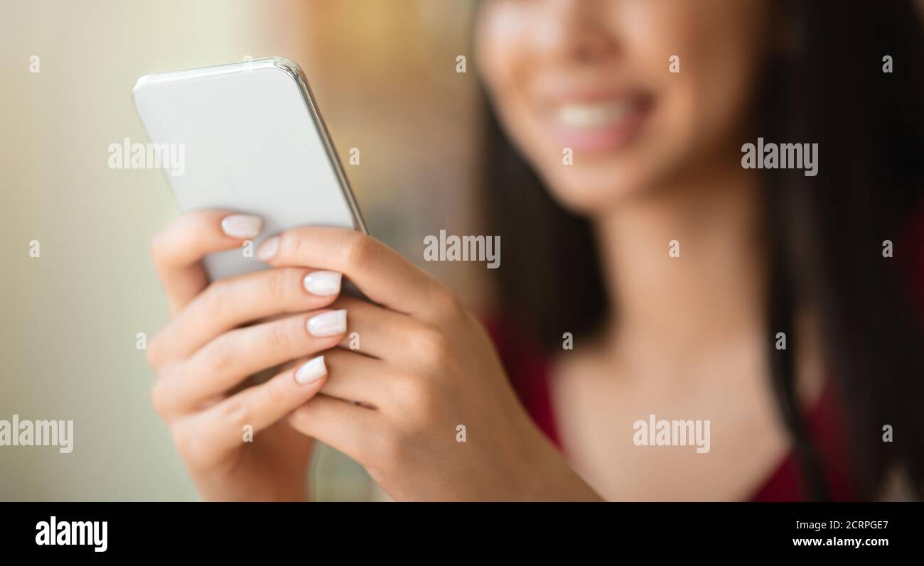 Closeup Image Of Unrecognizable Woman Using Modern Smartphone, Texting Or Browsing Internet Stock Photo