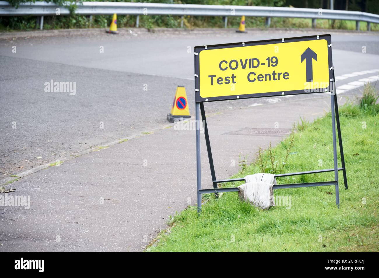 Covid-19 test centre sign at road with traffic cones Stock Photo