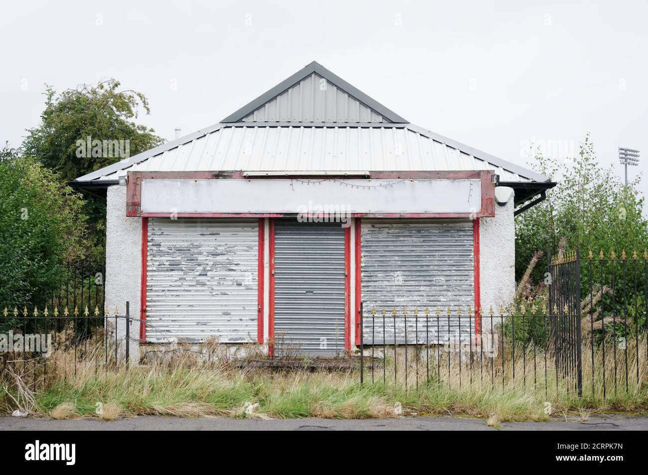 Derelict abandoned shop business in poor housing crisis ghetto estate slum Paisley Stock Photo