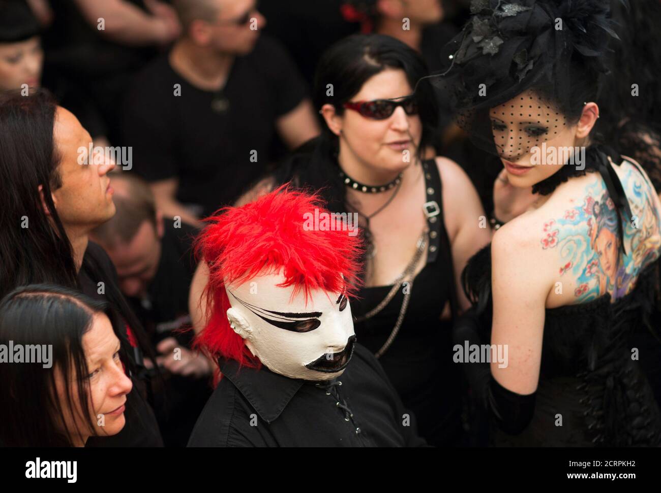 A revellers wears a plaster mask during concert at the Wave and Goth festival in Leipzig May 26, 2012. The annual festival, known in Germany as Wave-Gotik Treffen, features over 150 bands and artist in venues all over the city playing Gothic rock and other styles of the dark wave music subculture. The event that counts as one of the biggest of its kind attract a regular audience of up to 20,000 the organisers said.  REUTERS/Thomas Peter  (GERMANY - Tags: ENTERTAINMENT) Stock Photo